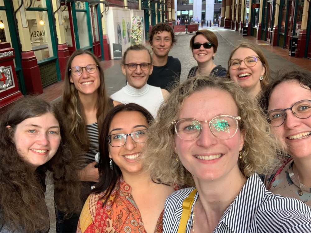 Group selfie of nine of our members in a cute London street.